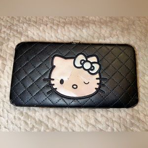 Hello Kitty black/ivory wallet. Used, has notable wear on corners.